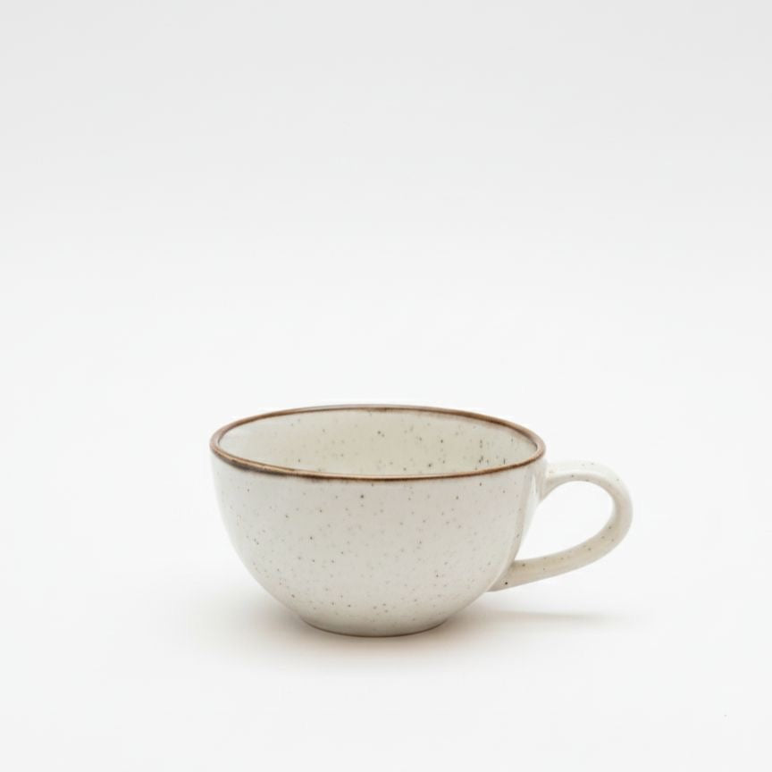 Speckled ceramic cup on a white background