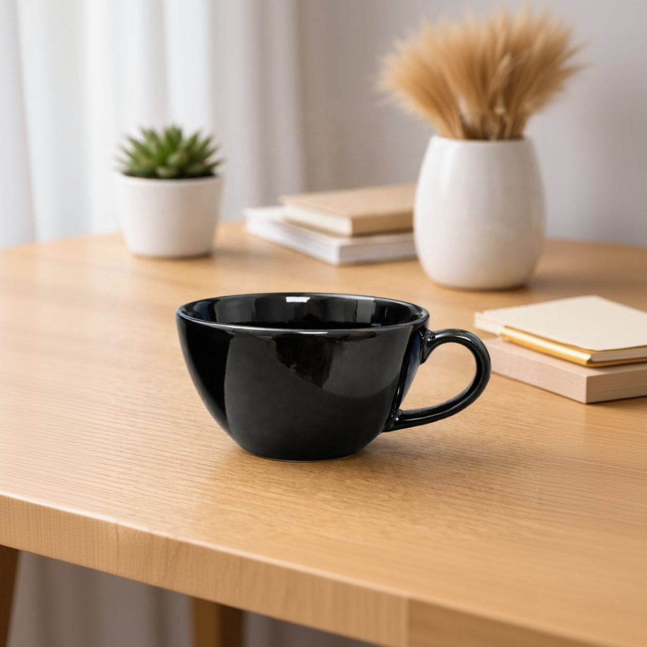Black ceramic mug on a wooden surface with a blurred background