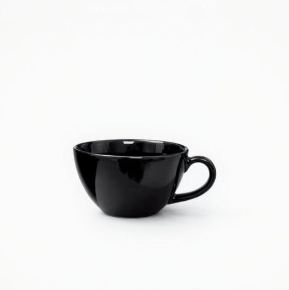 Black ceramic cup on a white background