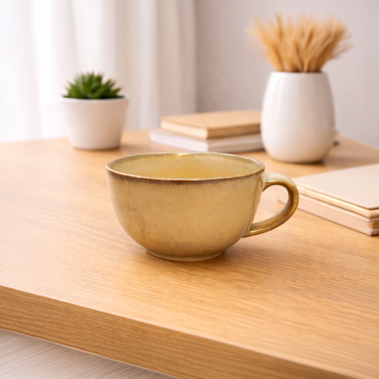 Gold mug on a wooden surface with books and plants in the background