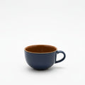 Navy blue mug with a brown interior on a white background