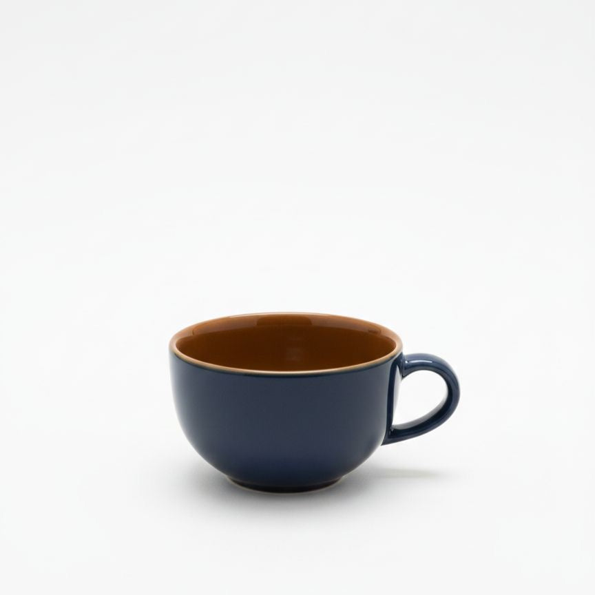 Navy blue mug with a brown interior on a white background