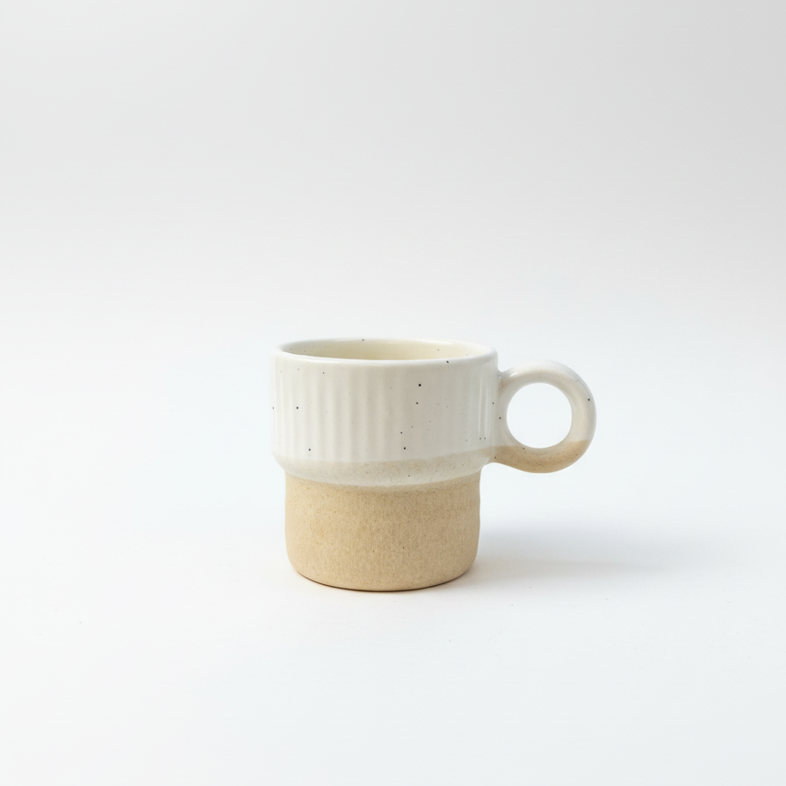 Two-toned ceramic mug with white top and beige bottom on a white background