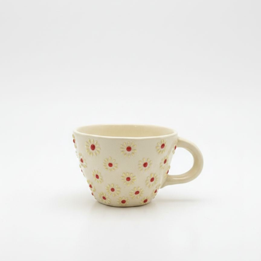 Ceramic mug with floral pattern on a white background